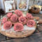 Faux wood flower blossoms hand painted in a dusty pink. Blossoms look like an English rose with layered petals with ruffles edges. 